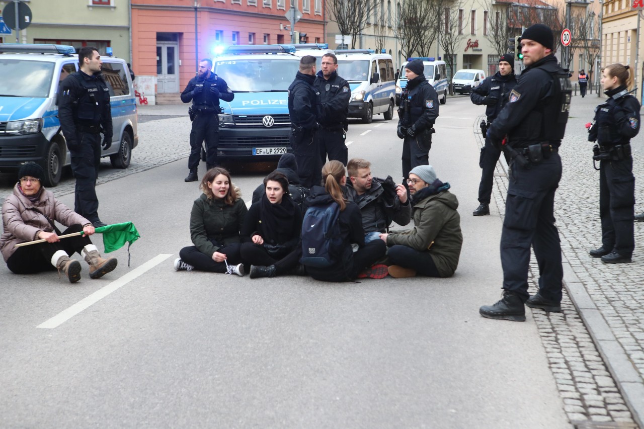 Gegendemonstranten sitzen auf einer Straße in der Innenstadt. Mehrere bürgerliche Gruppen mit insgesamt etwa 500 Teilnehmern haben gegen den Aufmarsch der Rechten demonstriert.