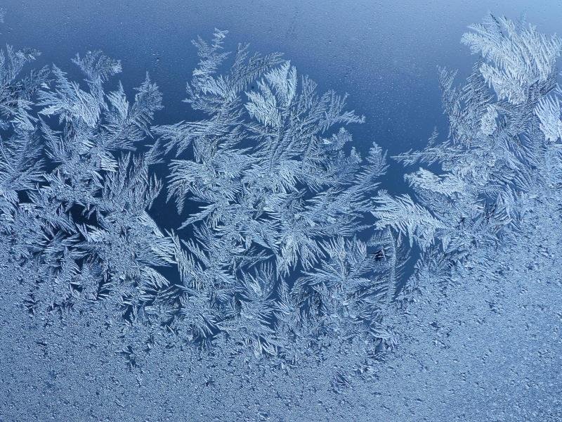 Eisblumen sind nach einer eisig kalten Nacht an einem Fenster im thüringischen Kleinhettstedt zu sehen.