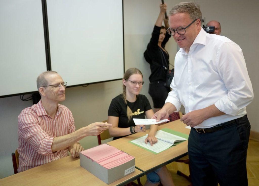 Mario Voigt (CDU), Vorsitzender der CDU in Thüringen und Spitzenkandidat seiner Partei, erhält seinen Stimmzettel für die Landtagswahl Thüringen im Wahllokal.